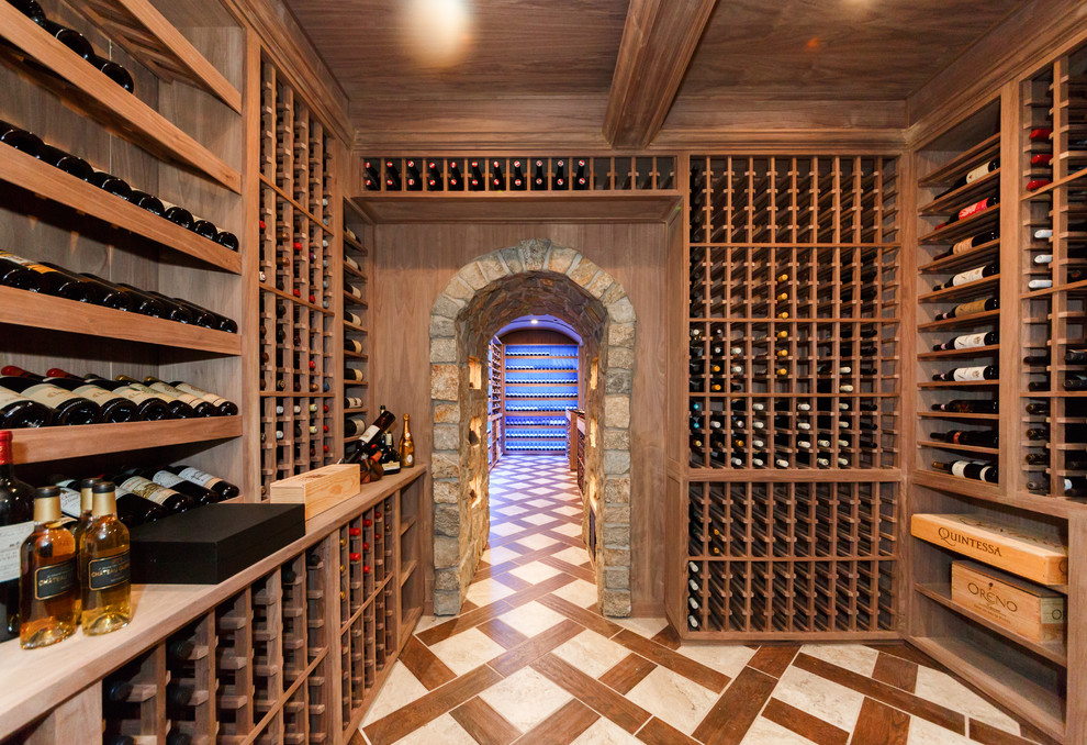 Photo of an expansive mediterranean wine cellar in New York with porcelain floors, brown floor and storage racks.