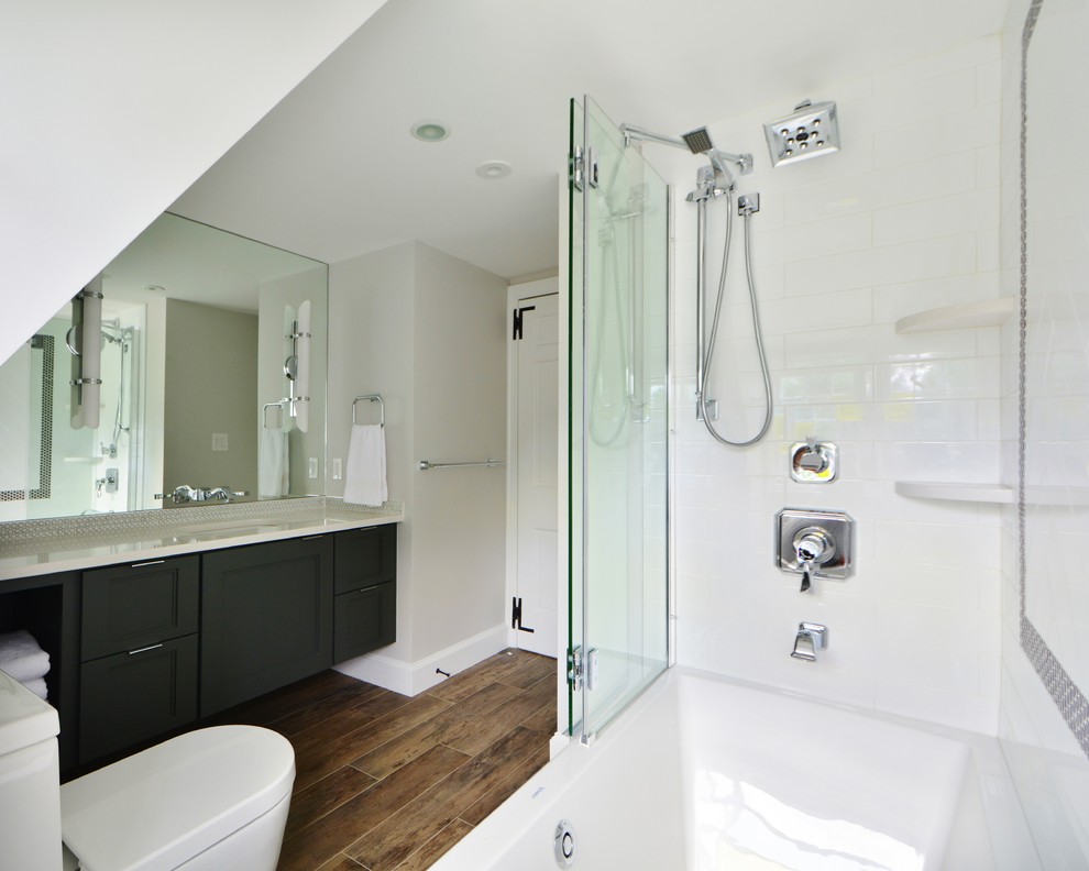 Example of a mid-sized transitional kids' gray tile and porcelain tile porcelain tile alcove bathtub design in Boston with an undermount sink, flat-panel cabinets, gray cabinets, quartz countertops, a one-piece toilet and gray walls