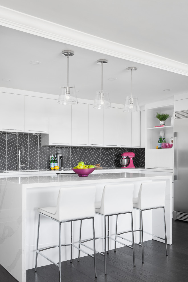 Inspiration for a large contemporary kitchen in Toronto with flat-panel cabinets, white cabinets, quartzite benchtops, grey splashback, ceramic splashback, stainless steel appliances, dark hardwood floors, with island and white benchtop.