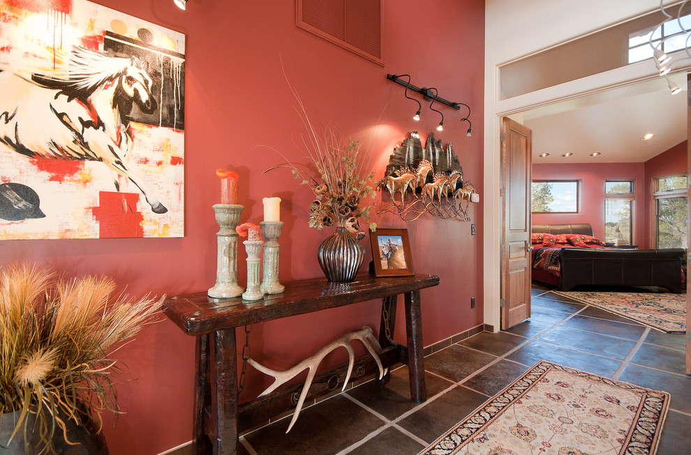 This is an example of an expansive transitional hallway in Phoenix with red walls and concrete floors.