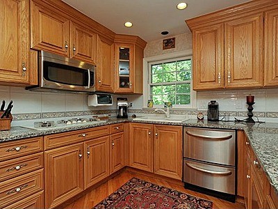 How do I fix faded knob patterns on my oak cabinets?