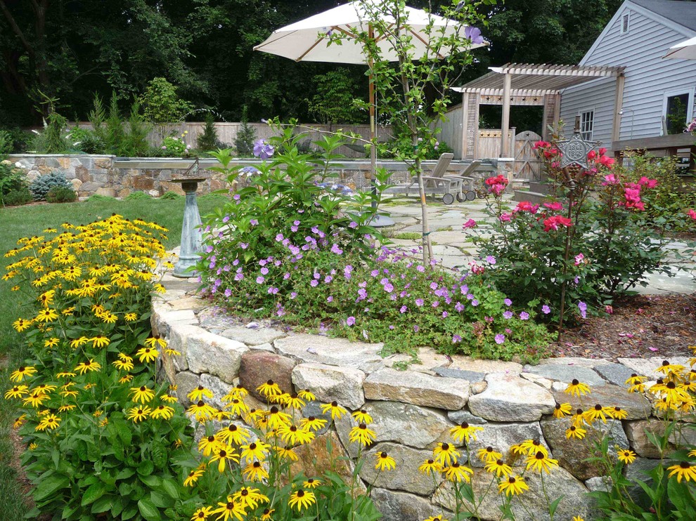 Photo of a beach style backyard full sun formal garden for summer in Bridgeport with natural stone pavers.