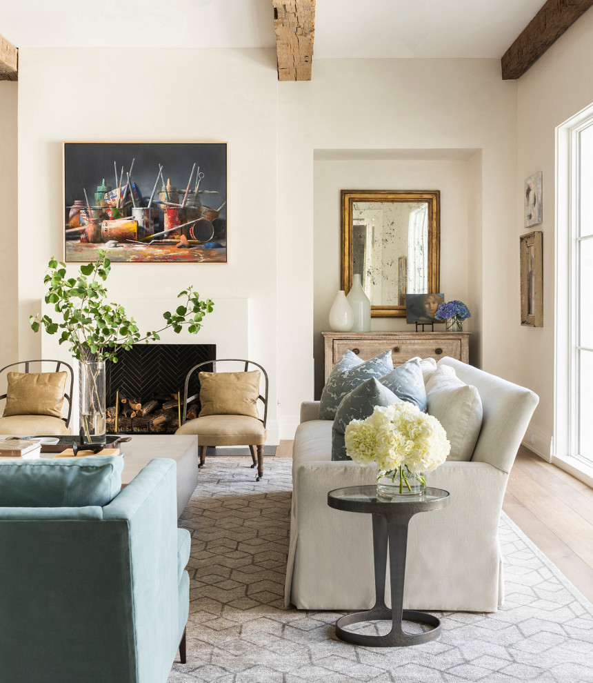 Design ideas for a transitional open concept family room in Houston with light hardwood floors, a plaster fireplace surround, a concealed tv and exposed beam.