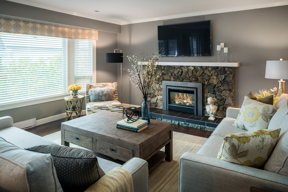 Design ideas for a mid-sized transitional formal enclosed living room in Vancouver with grey walls, a standard fireplace, dark hardwood floors, a stone fireplace surround, a wall-mounted tv and brown floor.