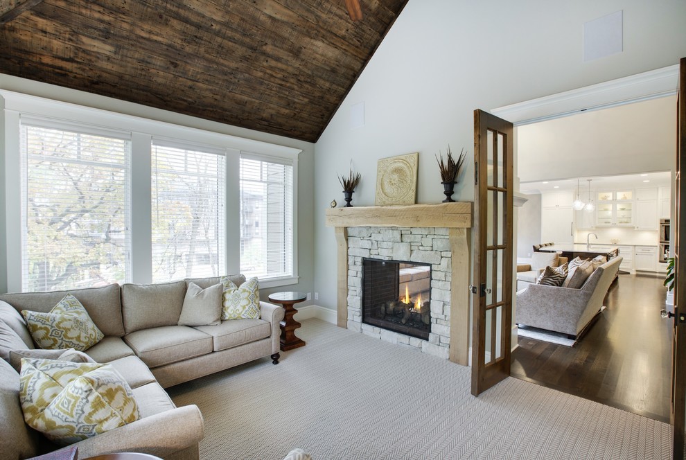 Sunroom in Minneapolis with carpet and a standard fireplace.