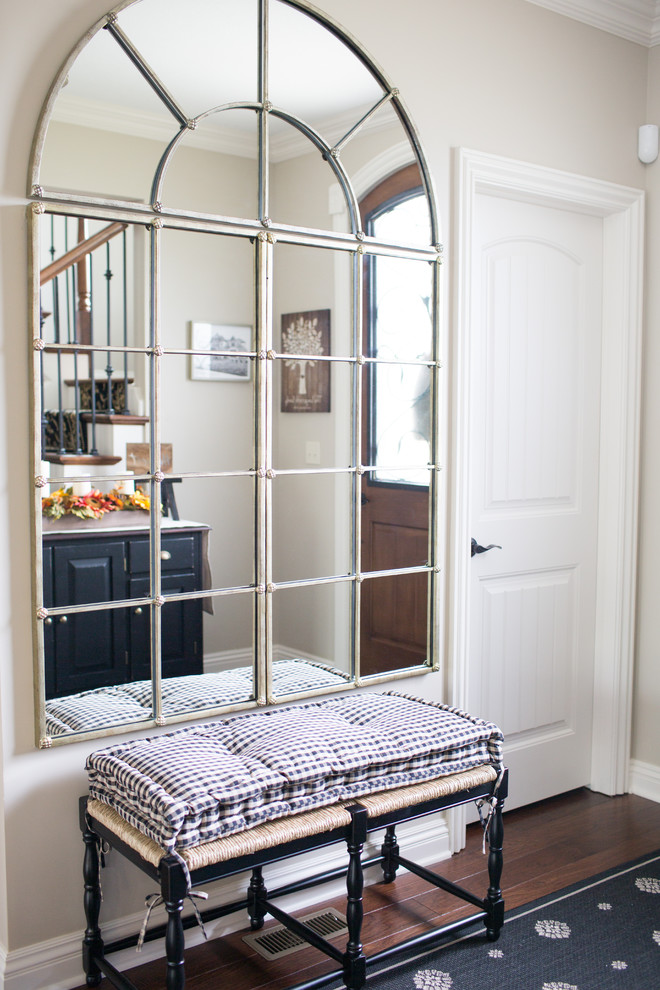 Inspiration for a mid-sized transitional medium tone wood floor and brown floor front door remodel with beige walls and a medium wood front door