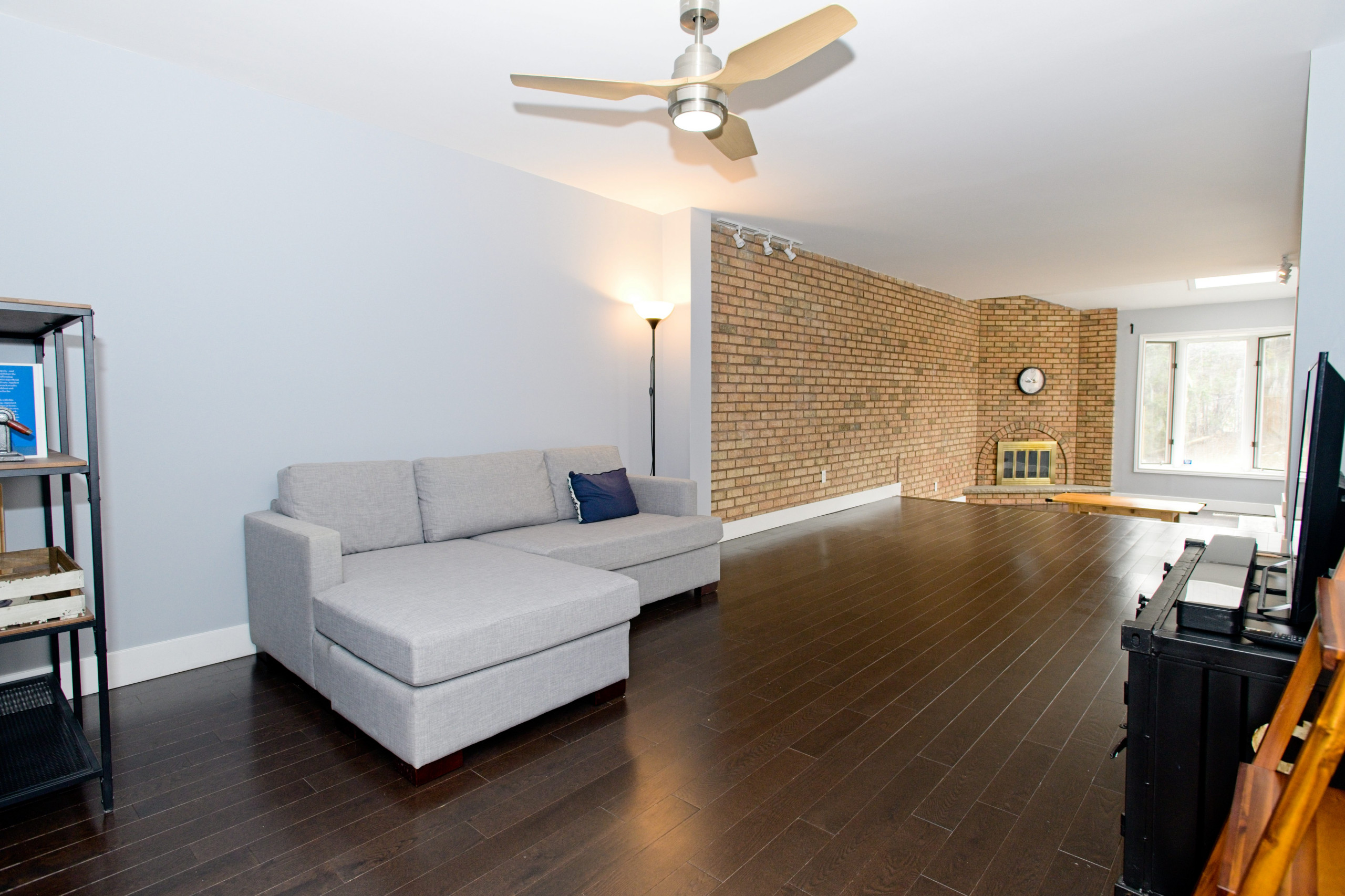 Open Living Room Space with Exposed brick and Fireplace