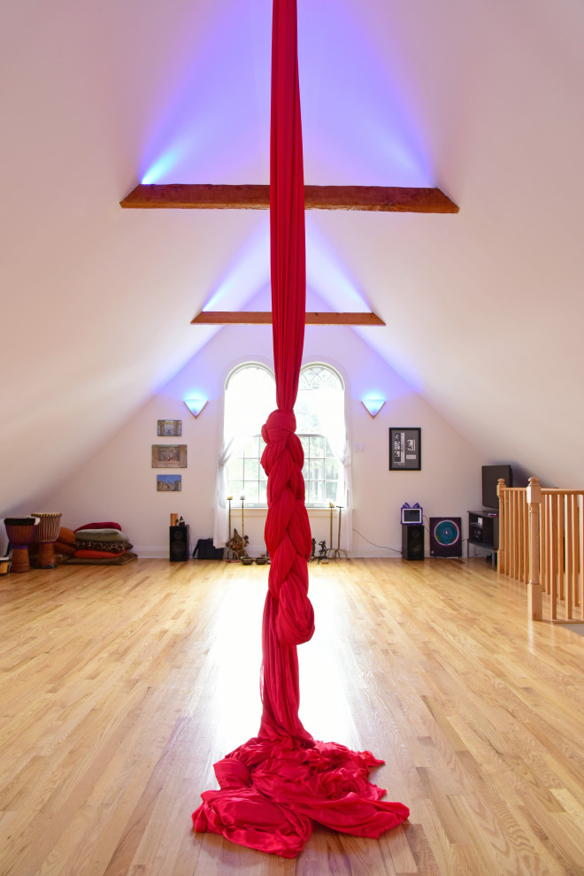 Inspiration for a large traditional home yoga studio in Boston with white walls and light hardwood floors.