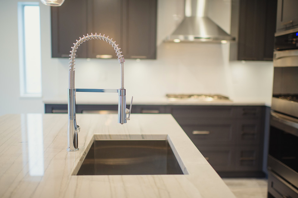 Example of a mid-sized transitional l-shaped eat-in kitchen design in Vancouver with a single-bowl sink, shaker cabinets, gray cabinets, marble countertops, white backsplash, stainless steel appliances and an island