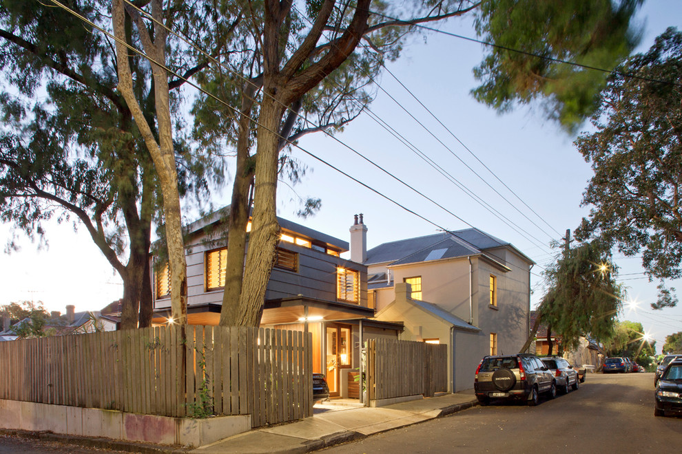 Inspiration for a modern two-storey beige exterior in Sydney with metal siding and a hip roof.