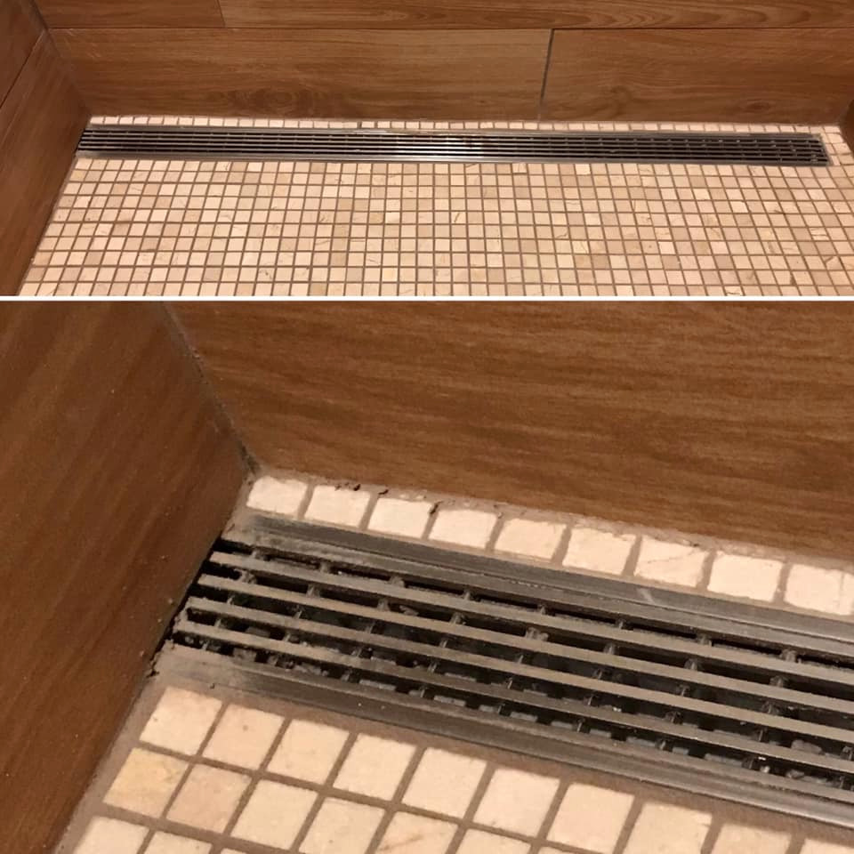 Linear drain cover grouted in and under tile