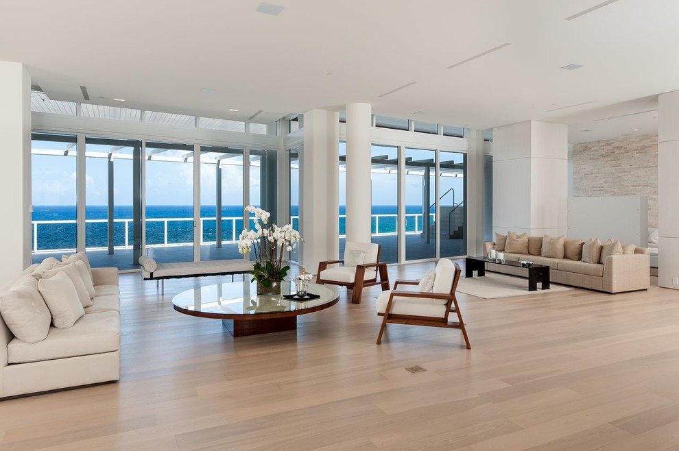 Photo of a contemporary formal open concept living room in Miami with light hardwood floors.