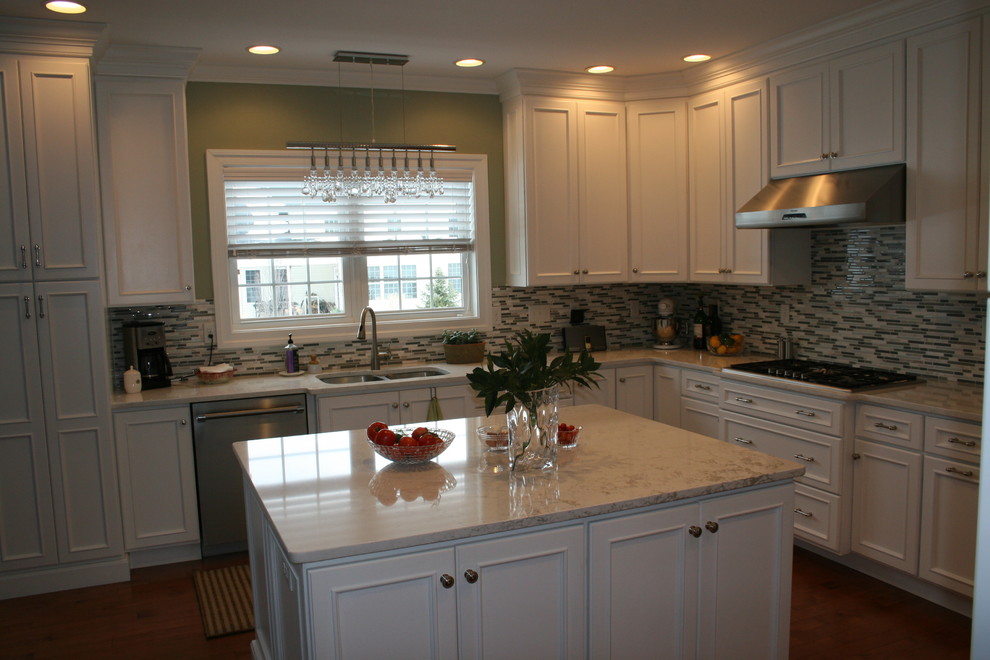 Photo of a transitional kitchen in Other with white cabinets, quartz benchtops and with island.