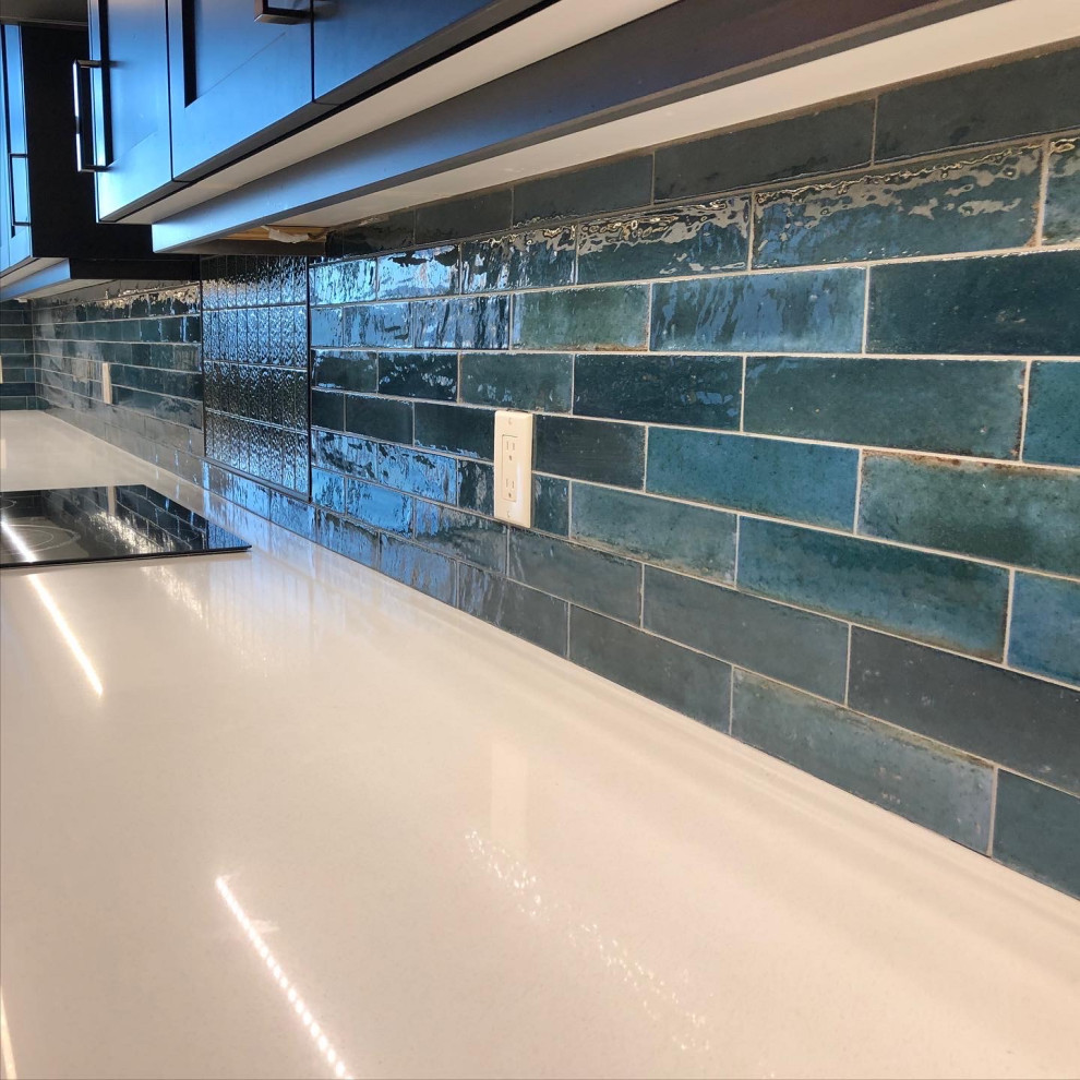Kitchen - kitchen idea with blue backsplash, ceramic backsplash and white countertops