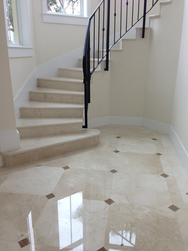 Photo of a large traditional tile curved staircase in Miami with tile risers.