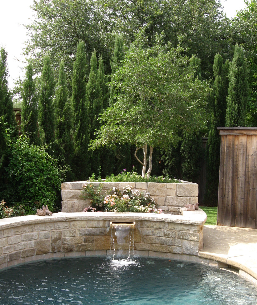 Inspiration for a small traditional backyard custom-shaped natural pool in Other with a water feature and stamped concrete.