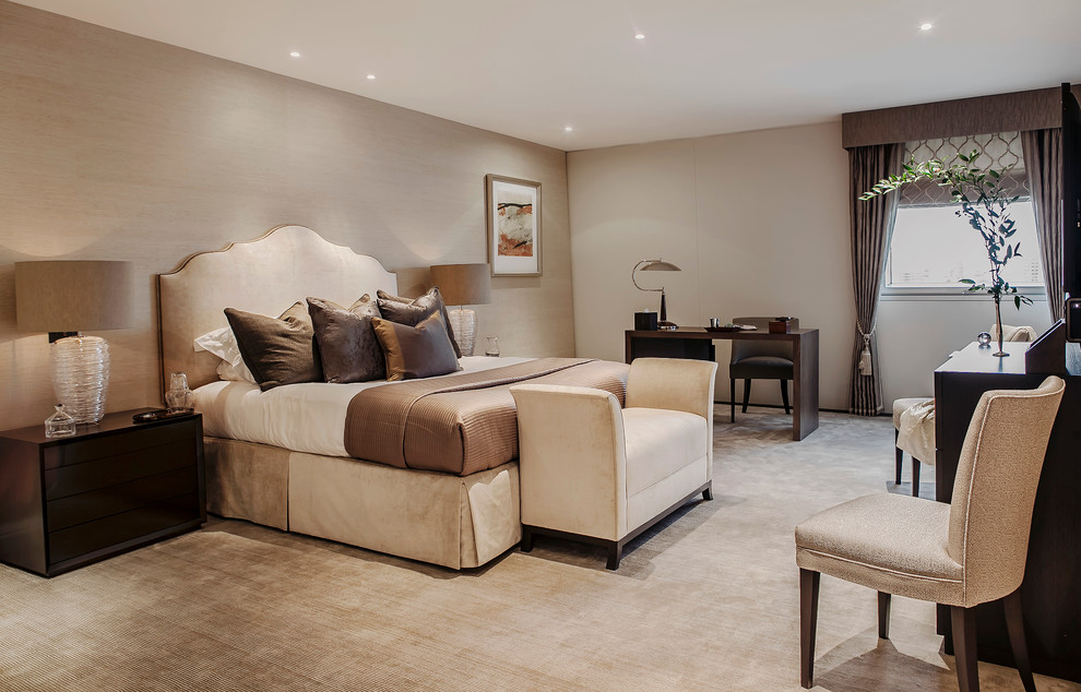 Inspiration for a transitional master bedroom in London with beige walls and carpet.