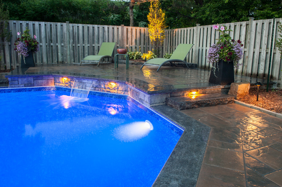 Inspiration for a modern backyard patio in Toronto with a water feature.