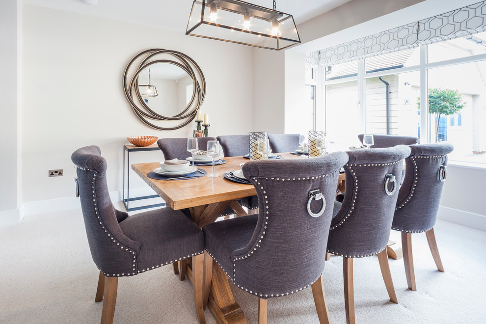 This is an example of a transitional dining room in Dorset.