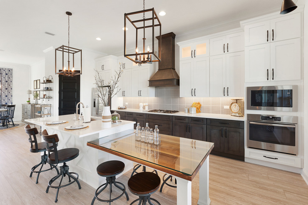 Inspiration for a large industrial single-wall open plan kitchen in Jacksonville with a single-bowl sink, shaker cabinets, white cabinets, quartz benchtops, black splashback, porcelain splashback, stainless steel appliances, vinyl floors, with island, grey floor and white benchtop.