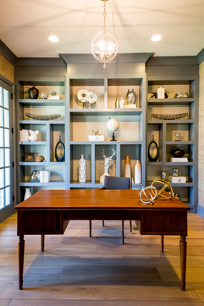 Inspiration for a transitional home office in Chicago with blue walls, medium hardwood floors and a freestanding desk.