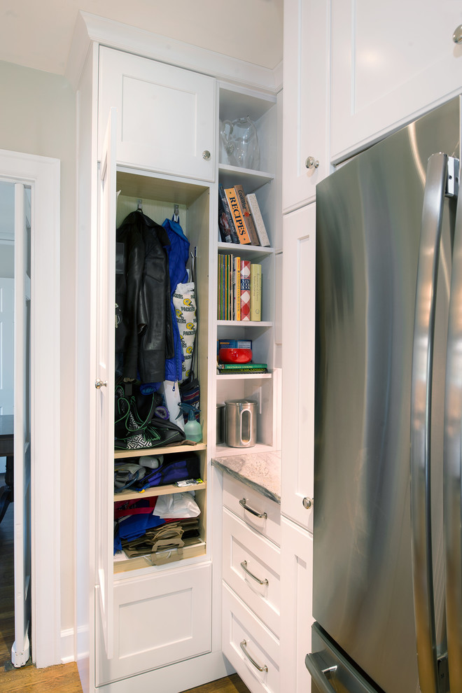 Closet - mid-sized transitional u-shaped medium tone wood floor closet idea with an undermount sink, shaker cabinets, white cabinets, granite countertops, gray backsplash, mosaic tile backsplash, colored appliances and an island