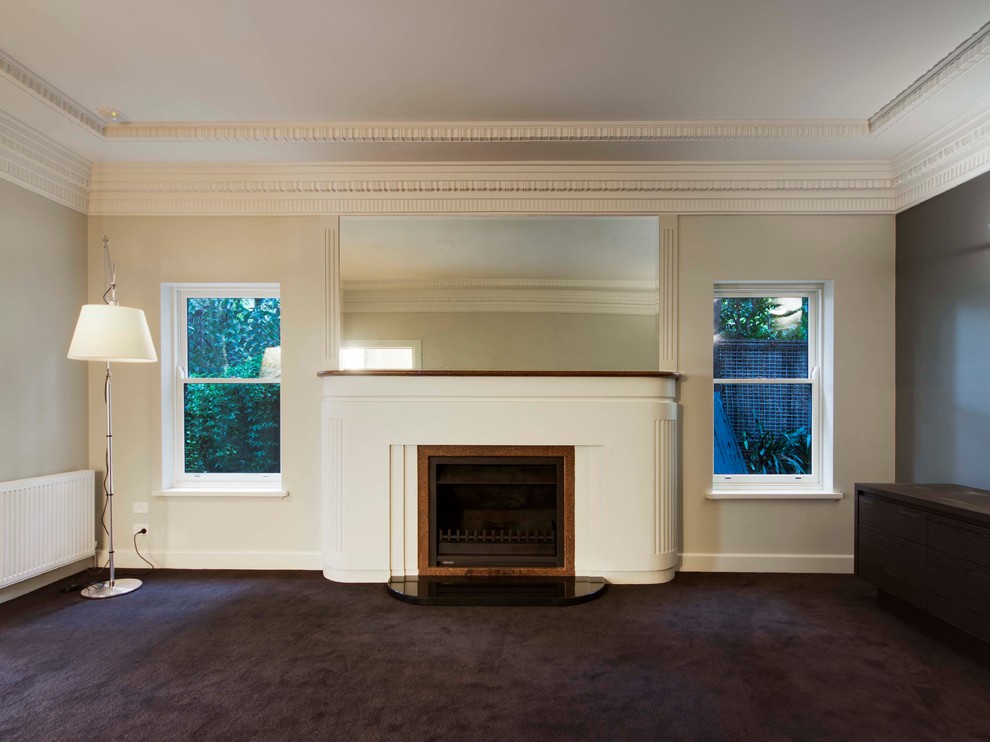 Photo of a large midcentury formal enclosed living room in Melbourne with beige walls, carpet, a standard fireplace, a stone fireplace surround and a freestanding tv.