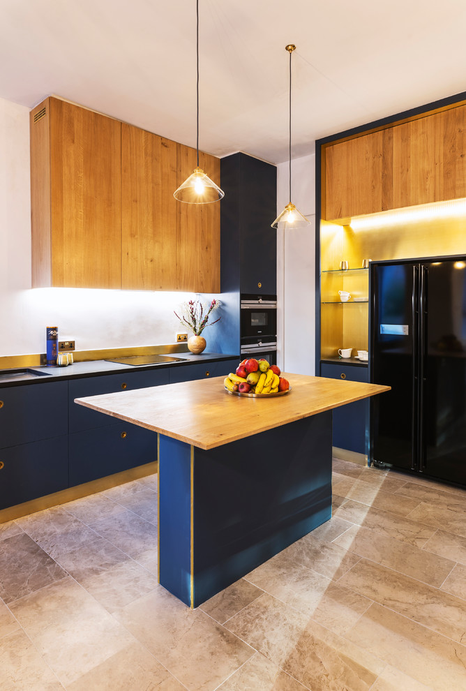 Inspiration for a modern open plan kitchen in Manchester with a single-bowl sink, metallic splashback, black appliances, marble floors, with island and black benchtop.