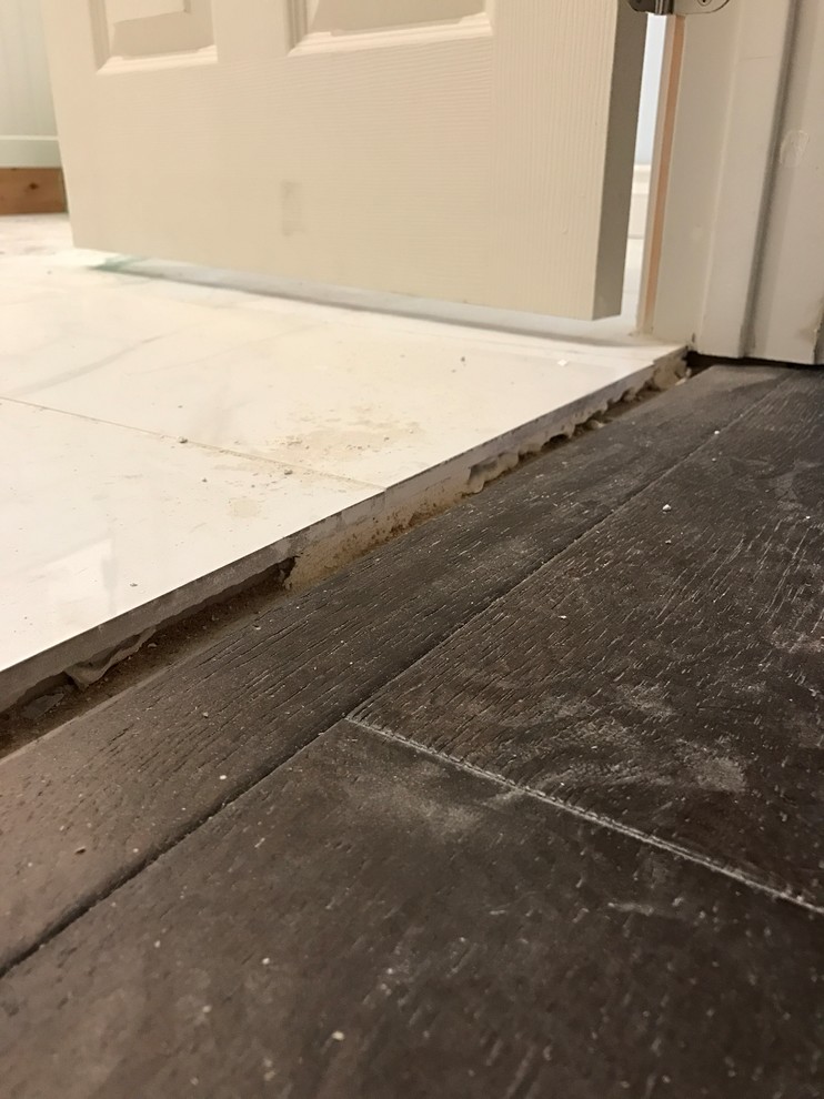 Need ideas on how best to cover uneven transition from wood to tile