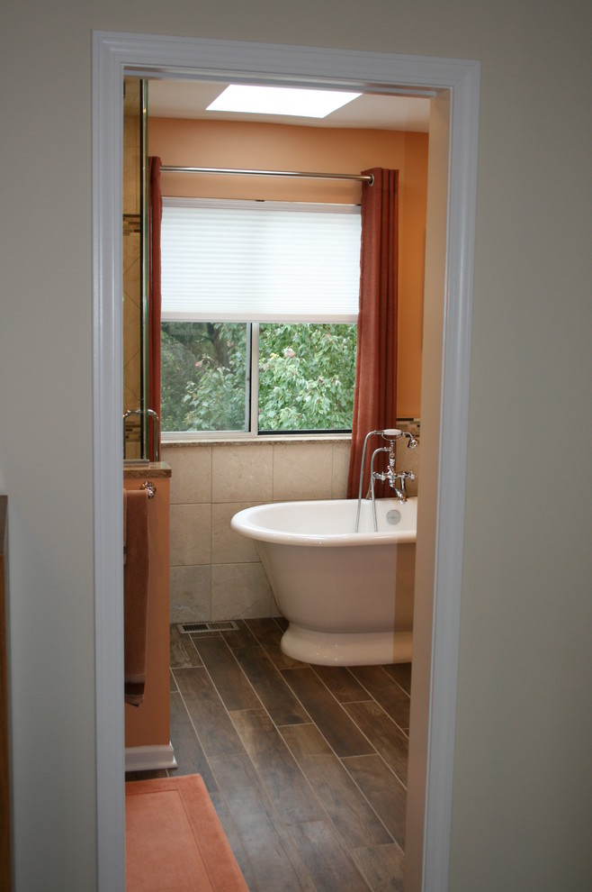 Design ideas for a mid-sized transitional master bathroom in Chicago with furniture-like cabinets, dark wood cabinets, a freestanding tub, an alcove shower, a two-piece toilet, beige tile, brown tile, matchstick tile, orange walls, ceramic floors, an undermount sink and granite benchtops.