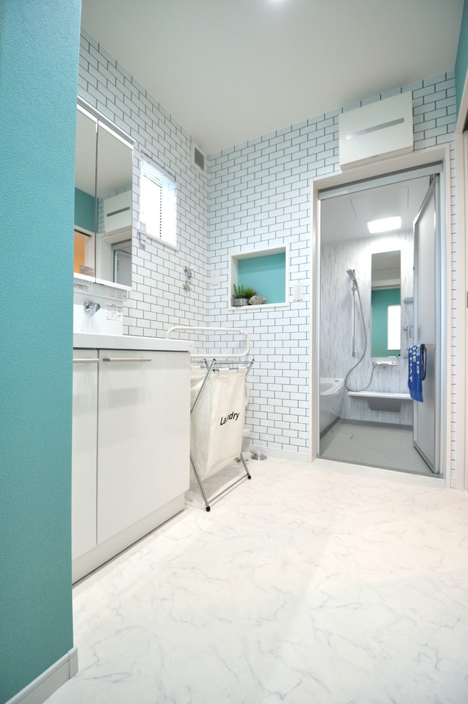 This is an example of a beach style powder room in Other.