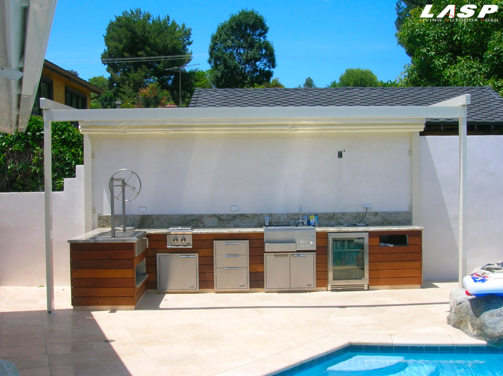 Inspiration for a small contemporary backyard patio in Los Angeles with an outdoor kitchen and a pergola.