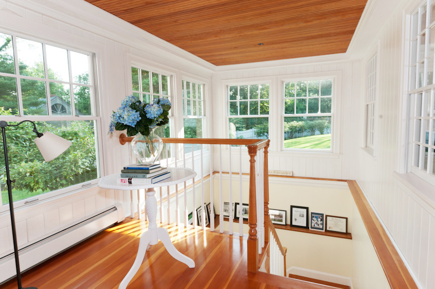 Photo of a mid-sized transitional wood u-shaped staircase in Boston with painted wood risers.