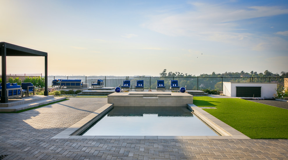 Großer Moderner Garten hinter dem Haus mit direkter Sonneneinstrahlung, Betonboden und Metallzaun in San Diego