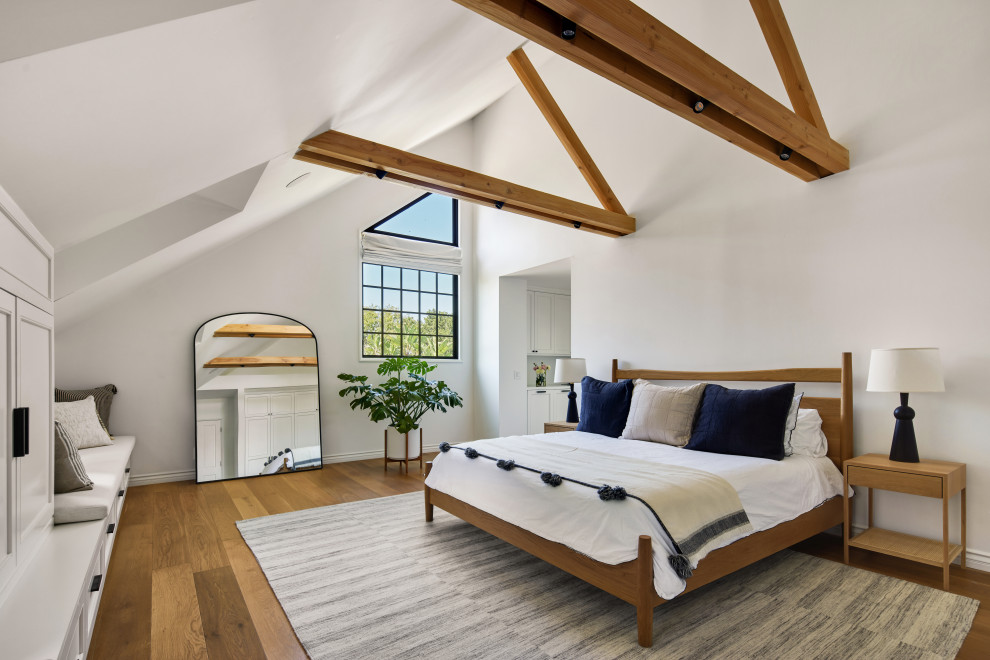 Inspiration for a large transitional master medium tone wood floor and beige floor bedroom remodel in Los Angeles with white walls and no fireplace