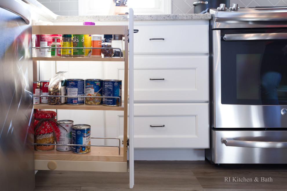 Inspiration for a large transitional l-shaped porcelain tile eat-in kitchen remodel in Providence with an undermount sink, recessed-panel cabinets, white cabinets, granite countertops, gray backsplash, ceramic backsplash, stainless steel appliances, green walls and an island
