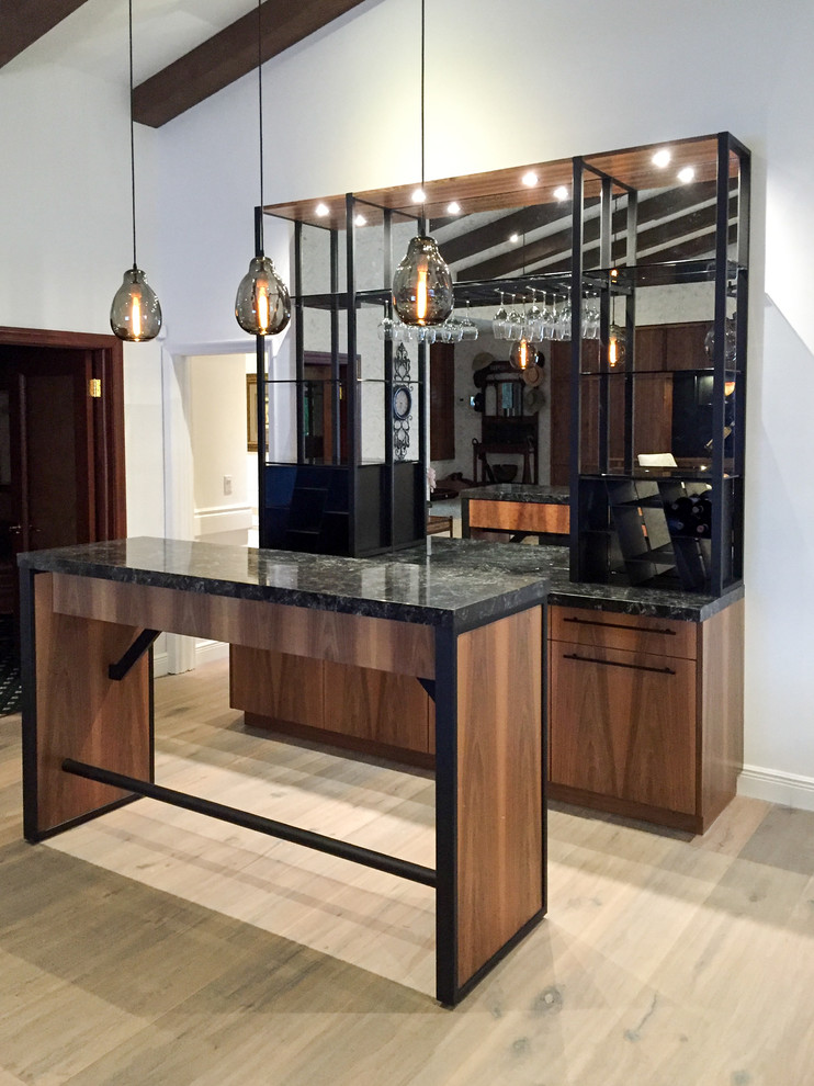 Mid-sized industrial single-wall seated home bar in Miami with flat-panel cabinets, dark wood cabinets, quartz benchtops, multi-coloured splashback, mirror splashback and light hardwood floors.