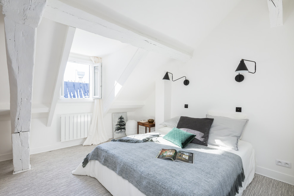 This is an example of a mid-sized scandinavian master bedroom in Paris with white walls, carpet and grey floor.