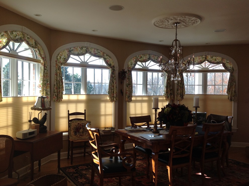 This is an example of a large traditional kitchen/dining combo in Other with brown walls, medium hardwood floors, no fireplace and brown floor.