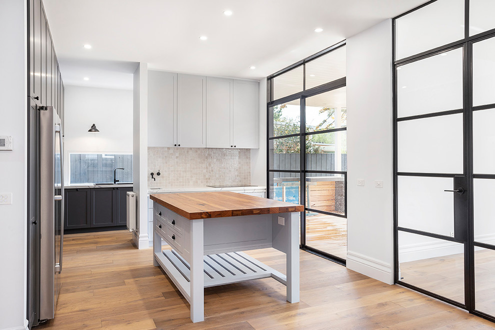 Transitional kitchen in Melbourne with shaker cabinets.