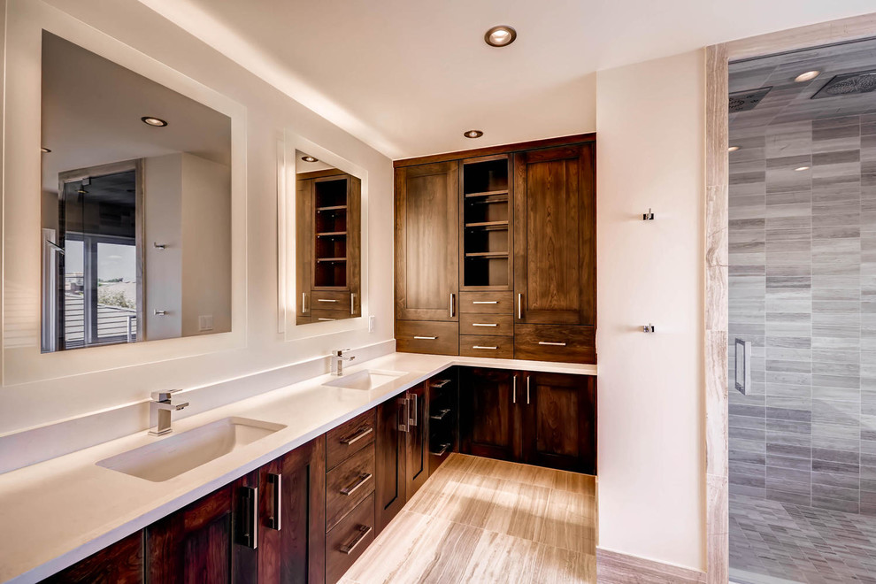 Corner shower - huge transitional beige tile ceramic tile corner shower idea in Denver with shaker cabinets, dark wood cabinets, an undermount sink and quartz countertops