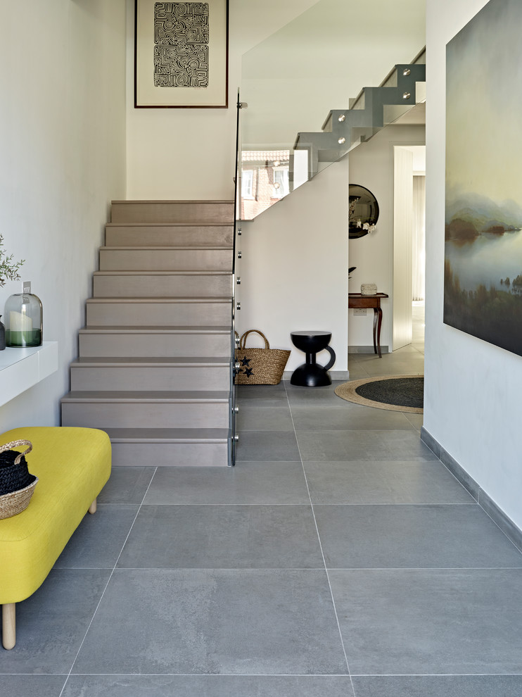 Photo of a large modern hallway in London with white walls, slate floors and grey floor.