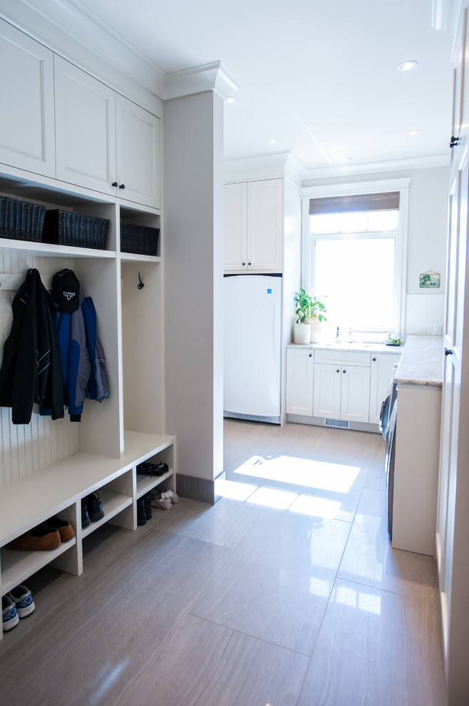 Design ideas for a mid-sized traditional mudroom in Calgary with porcelain floors.