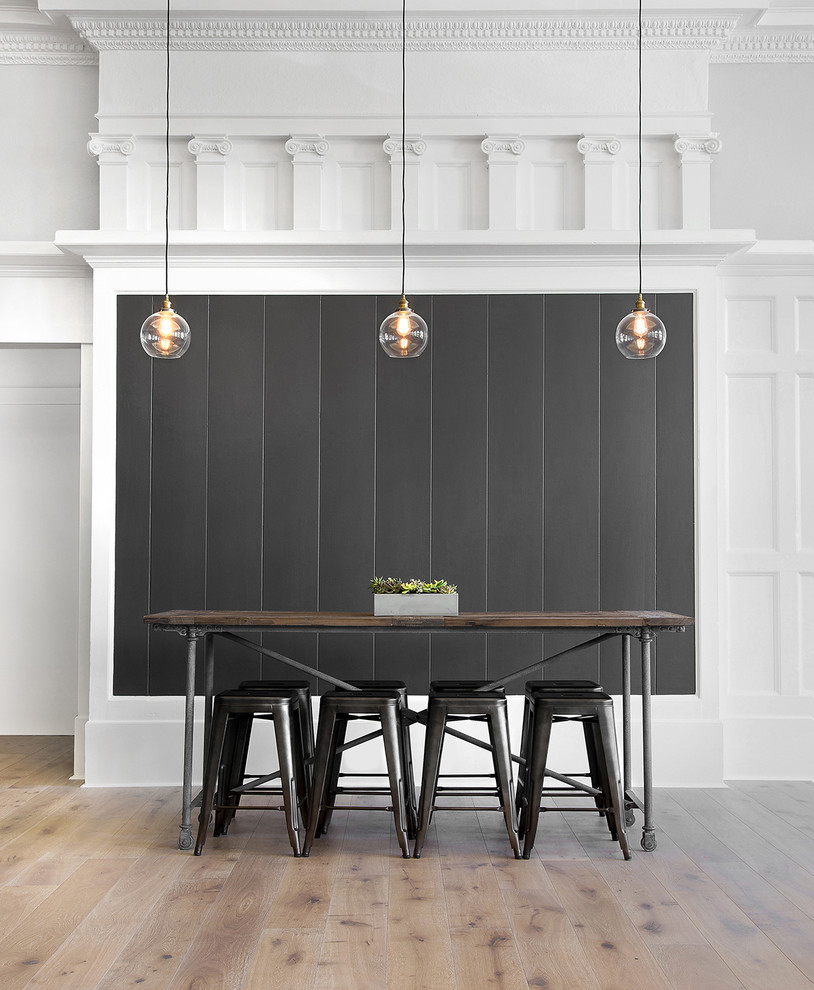 This is an example of a transitional dining room in San Francisco with grey walls and light hardwood floors.