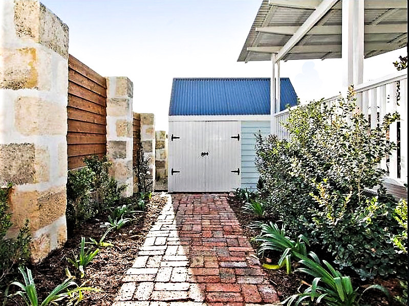 Photo of a small country side yard partial sun garden for summer in Perth with a garden path and concrete pavers.