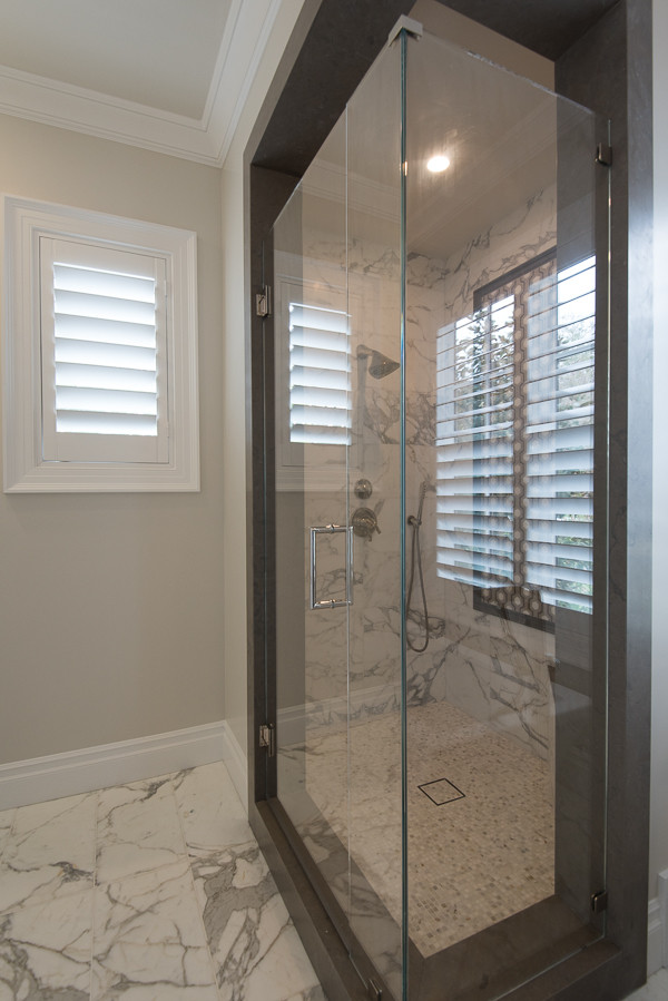 Inspiration for a transitional master bathroom in Los Angeles with a corner shower, grey walls, marble floors, white floor and a hinged shower door.