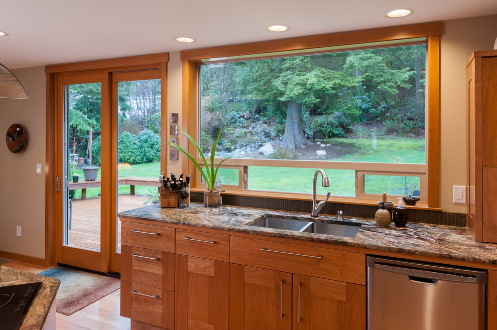 Photo of a mid-sized transitional l-shaped open plan kitchen in Seattle with a double-bowl sink, flat-panel cabinets, medium wood cabinets, marble benchtops, stainless steel appliances, medium hardwood floors and with island.