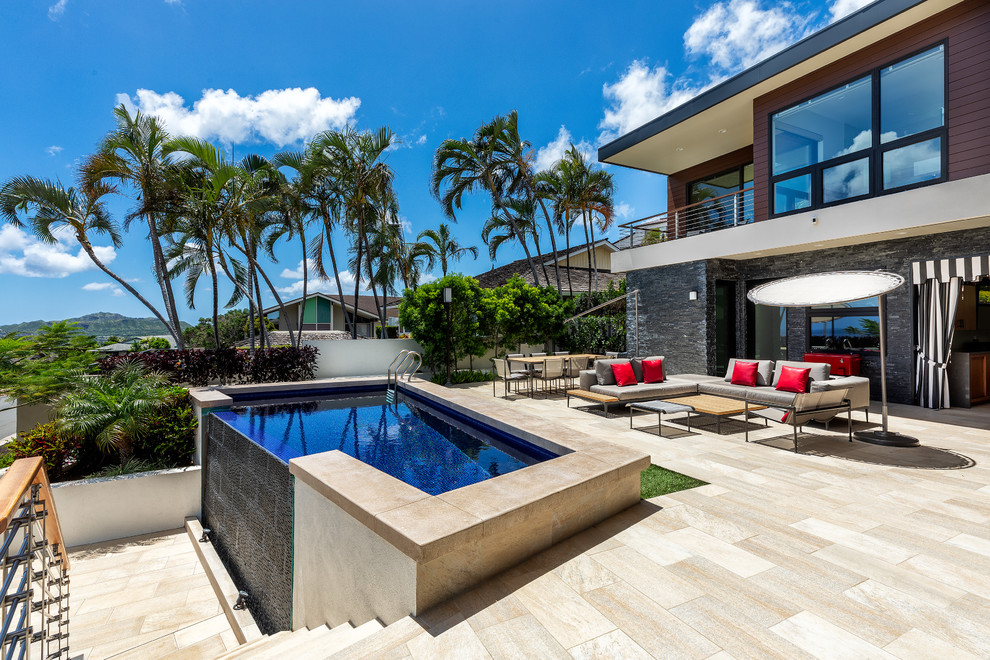 Design ideas for a mid-sized modern backyard custom-shaped infinity pool in Hawaii with tile.