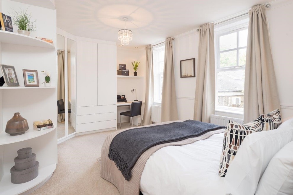 This is an example of a mid-sized contemporary bedroom in London with white walls, carpet and beige floor.
