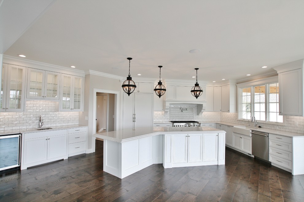 Inspiration for a transitional kitchen remodel with a farmhouse sink, flat-panel cabinets, quartz countertops and paneled appliances